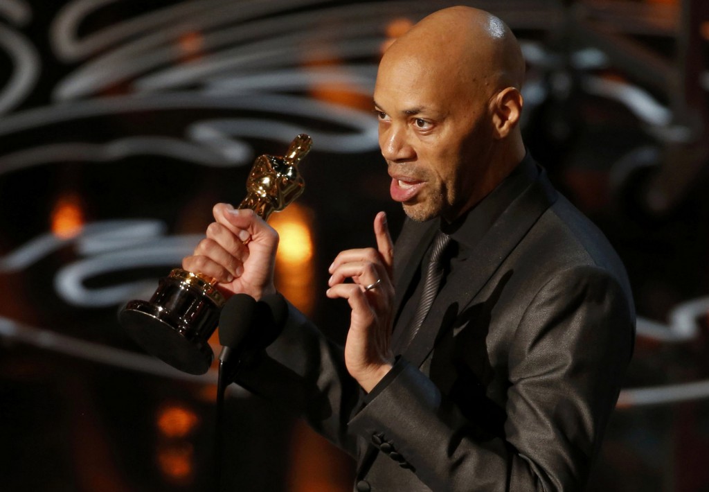 John Ridley accepts the Oscar for adapted screenplay for "12 Years a Slave" at the 86th Academy Awards in Hollywood